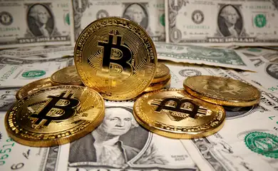 FILE PHOTO: Representations of virtual currency Bitcoin are placed on U.S. Dollar banknotes
