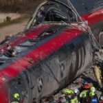 Members of the Spanish Civil Guard, along with other emergency personnel, work next to one of the trains involved in the accident, at the site of a deadly derailment of two high-speed trains near Adamuz, in Cordoba, Spain, January 19, 2026. REUTERS/Susana Vera