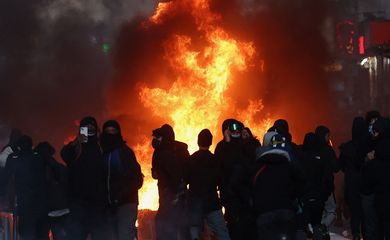 Flames and smoke rise during civil unrest, the day after a national day of demonstrations against the cost of living and rising fuel prices, in Paris, France, October 18, 2026. REUTERS/Abdul Saboor